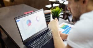 person using black laptop on table