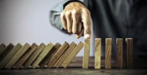 man holding block from toppling