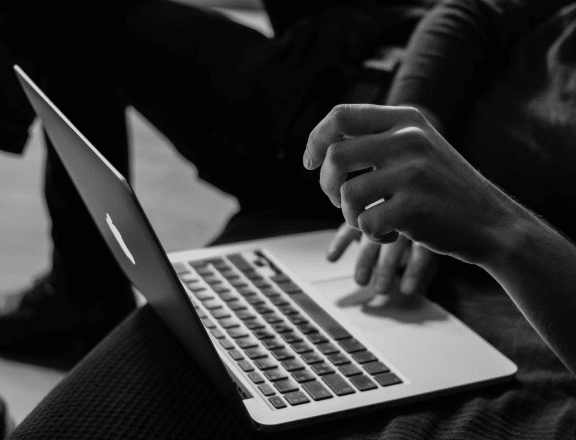 hands over macbook keyboard